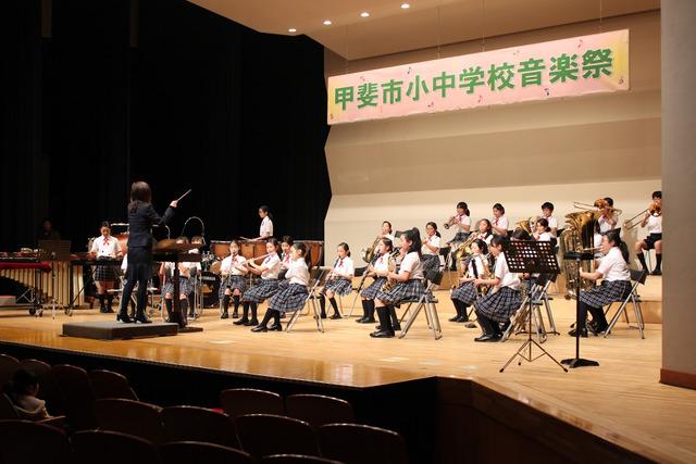 制服で演奏する竜王北小学校吹奏楽部の写真