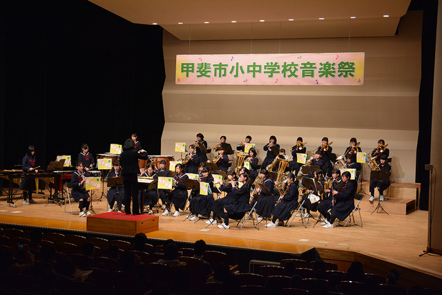 制服で演奏する竜王中学校・玉幡中学校吹奏楽部(合同演奏)の写真