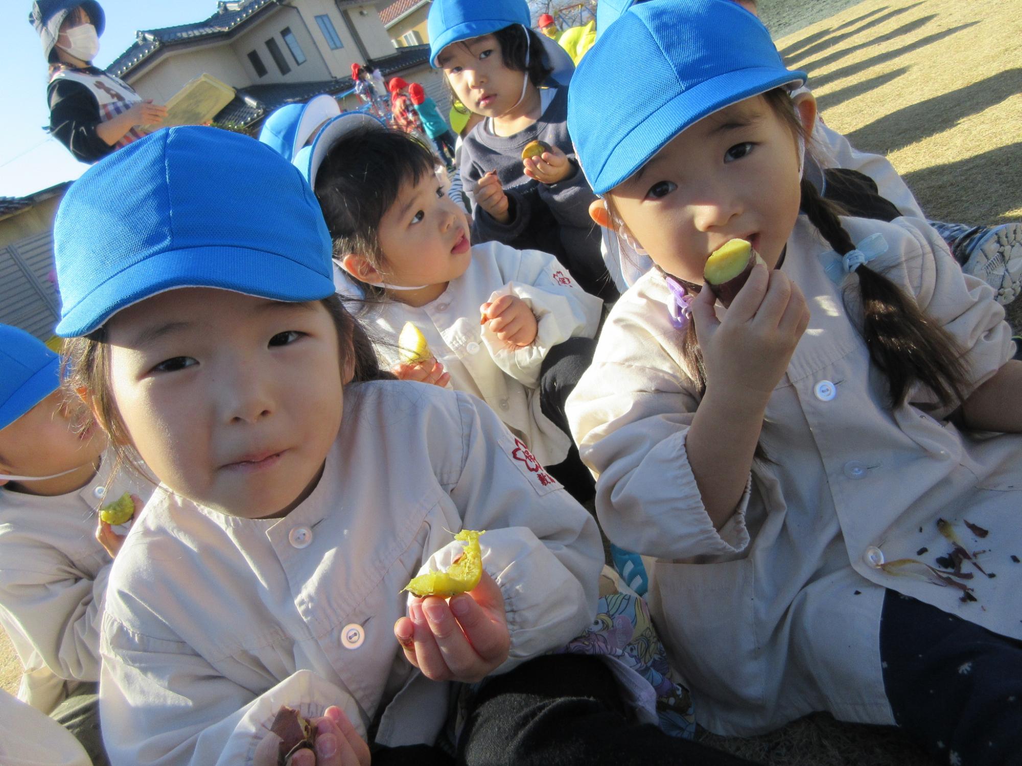 焼きいもを食べる3歳児