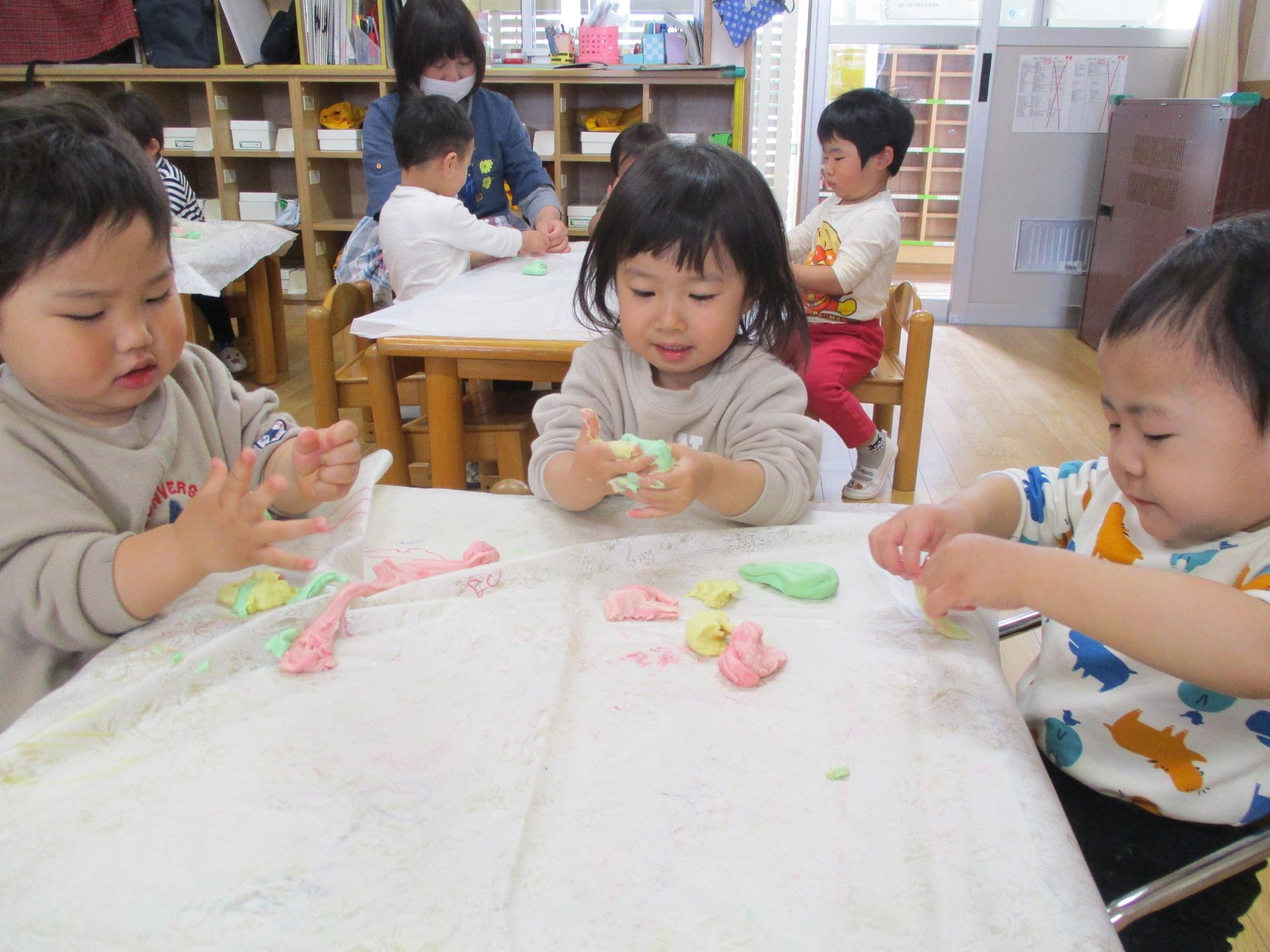 小麦粉粘土で遊ぶつぼみ2組の子供たちです。