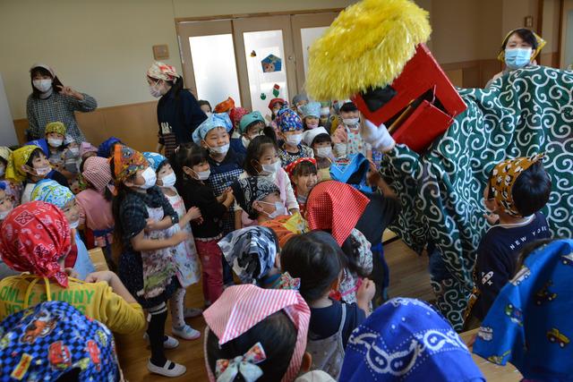 獅子舞と園児たちが交流している写真