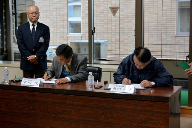 (写真)協定書に調印する各自治会区長(1枚目)