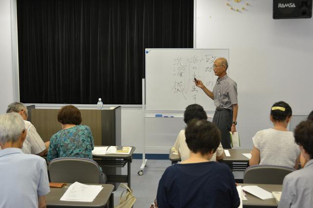 堀内さんがホワイトボードを使用し参加者の前で説明をしている写真