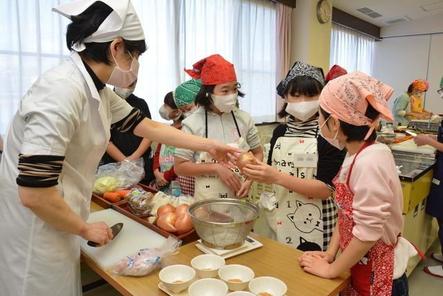 委員さんから具材を手渡されている子どもたちの写真