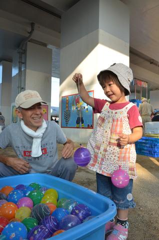 ヨーヨーを釣って笑顔になっている女の子の写真