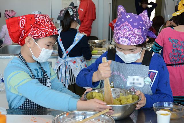 (写真)木べらで一生懸命に練り、「芋きんとん」を料理