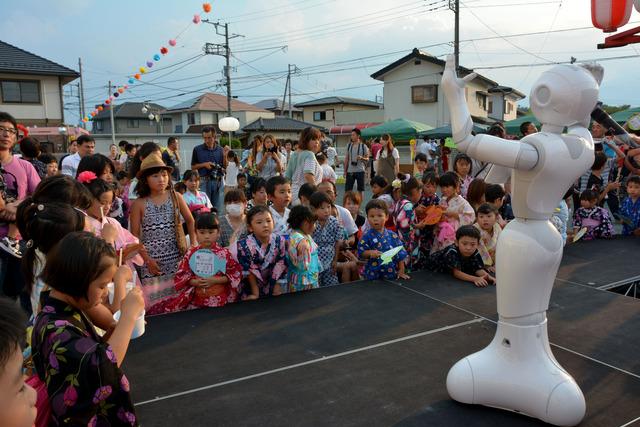 竜王西保育園の園庭にて「Pepper（ペッパー）」のダンスなどのショーを見ている子供たちの写真