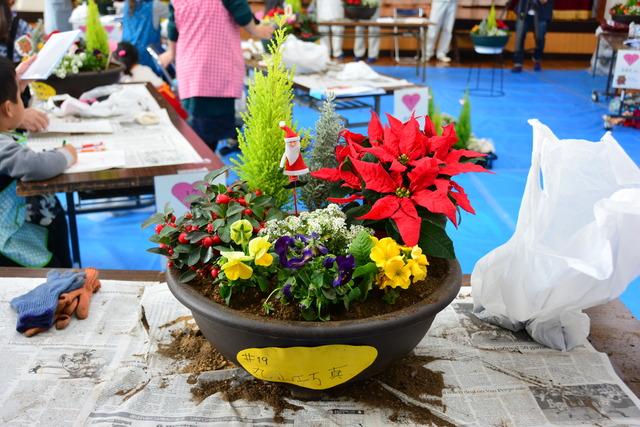 サンタクロースの飾りがついた色とりどりの鉢植えの写真