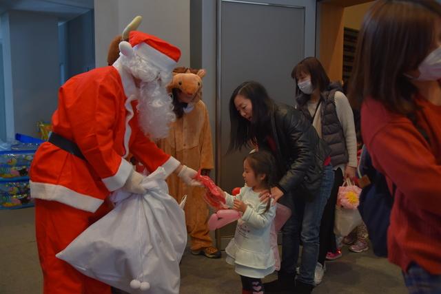 (写真)子どもにプレゼントを配るサンタクロース