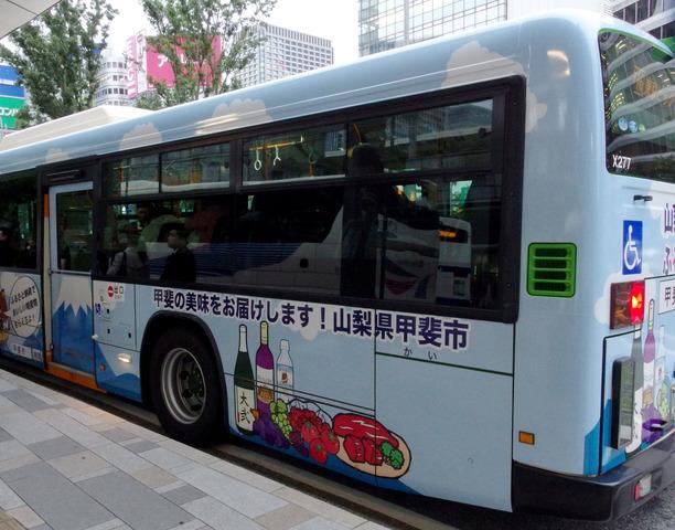 芋焼酎「大弐」、甲州ワインビーフ、龍王源水、ワイン、ぶどうなどのイラストが描かれたバスの写真