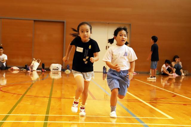 子供2人が一生懸命走っている写真