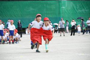 大きなパンツを2人で履いて走っている赤組の児童