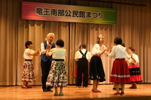 北欧の民族衣装を身にまといダンスをする人の写真