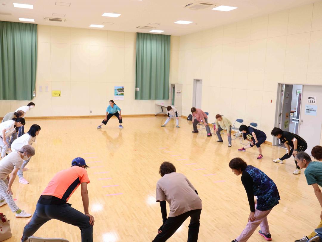 円になってストレッチする参加者